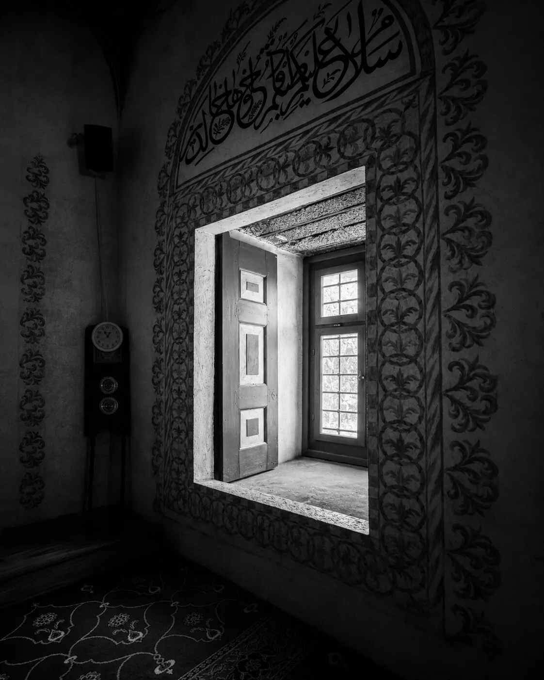 A painted window niche inside the Hadum Mosque, framed by calligraphy and floral motifs.